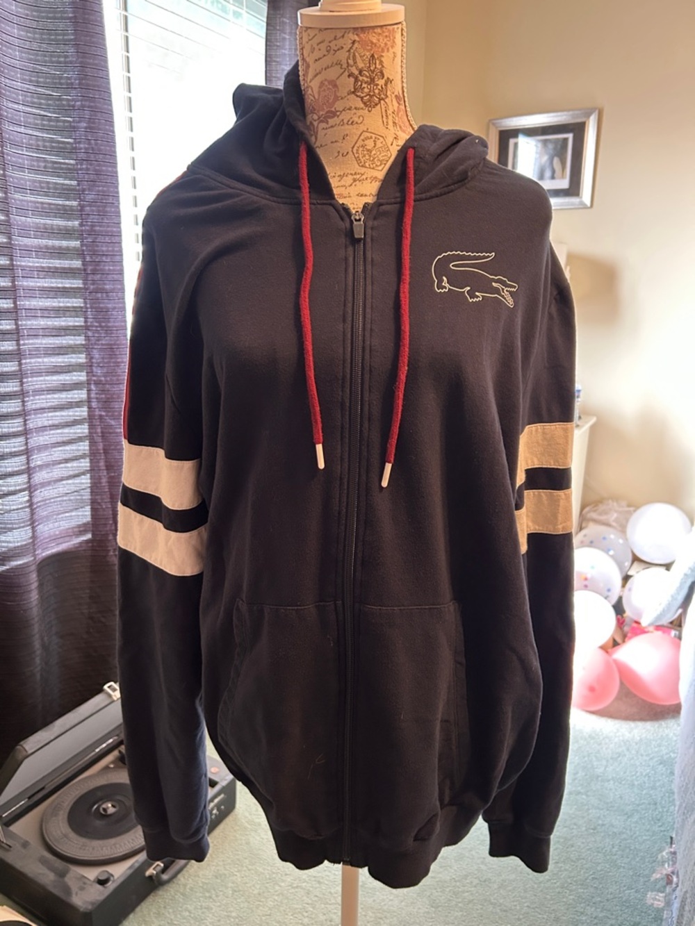 Lacoste Black Zip Hoodie with Cream Sleeve Stripes and Red Drawstrings